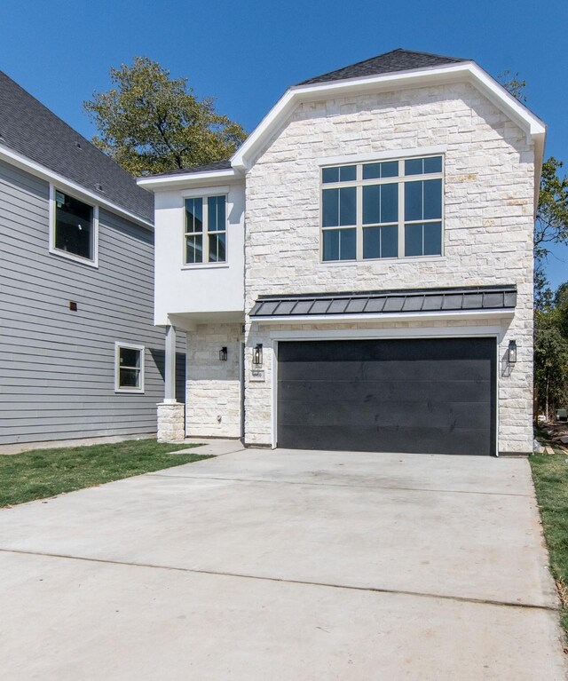 4910 Wunder Way, Houston, TX 77069 - view of front of home featuring stone siding, a standing seam roof, concrete driveway, a garage, and a metal roof