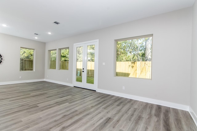 4910 Wunder Way, Houston, TX 77069 - empty room with wood finished floors, french doors, plenty of natural light, and recessed lighting