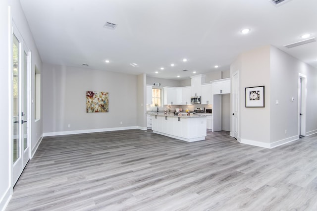 4910 Wunder Way, Houston, TX 77069 - unfurnished living room with light wood-type flooring, recessed lighting, and french doors
