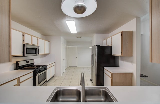 3618 Teakwood Ln, Pearland, TX 77584 - kitchen featuring stainless steel appliances, light countertops, light tile patterned floors, and a textured ceiling
