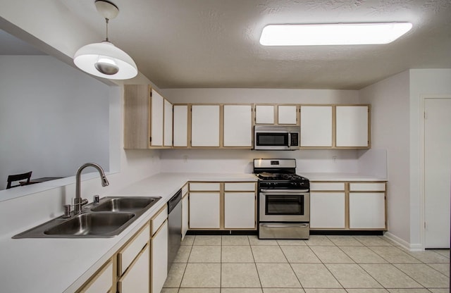 3618 Teakwood Ln, Pearland, TX 77584 - kitchen with stainless steel appliances, light countertops, light tile patterned floors, decorative light fixtures, and a textured ceiling