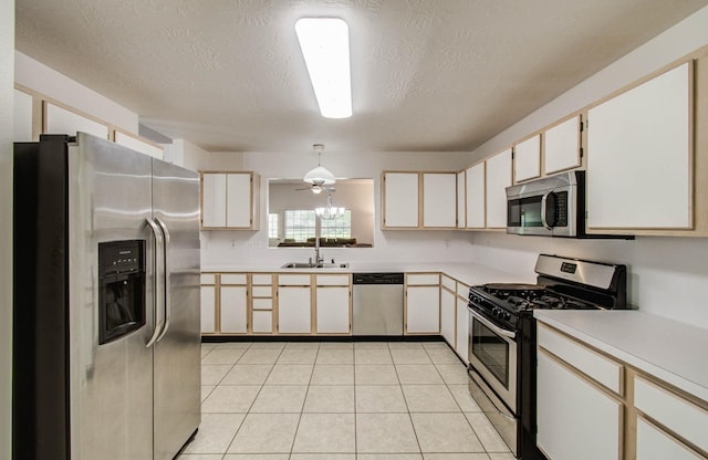 3618 Teakwood Ln, Pearland, TX 77584 - kitchen featuring appliances with stainless steel finishes, light countertops, a textured ceiling, light tile patterned floors, and a ceiling fan