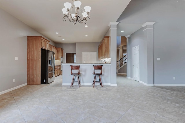 2226 Arrowwood Trl, Katy, TX 77494 - kitchen featuring stainless steel fridge with ice dispenser, light tile patterned flooring, ornate columns, recessed lighting, and a peninsula