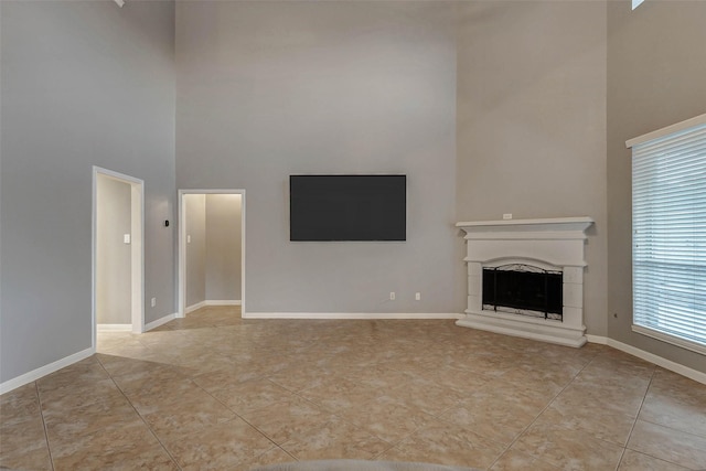 2226 Arrowwood Trl, Katy, TX 77494 - unfurnished living room with a high ceiling, a fireplace with raised hearth, and light tile patterned floors