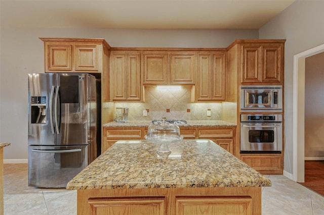 2226 Arrowwood Trl, Katy, TX 77494 - kitchen featuring appliances with stainless steel finishes, light stone countertops, decorative backsplash, and light tile patterned flooring