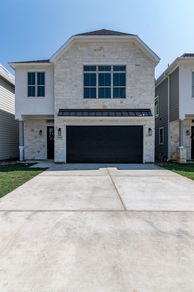 15034 Wunderlust Ln, Houston, TX 77069 - view of front of home featuring a garage, concrete driveway, stone siding, and a standing seam roof
