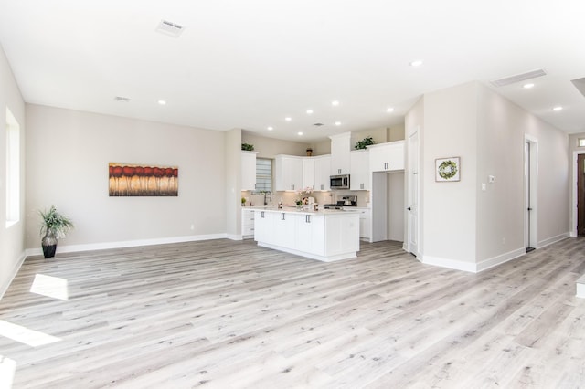 15034 Wunderlust Ln, Houston, TX 77069 - unfurnished living room with light wood finished floors and recessed lighting