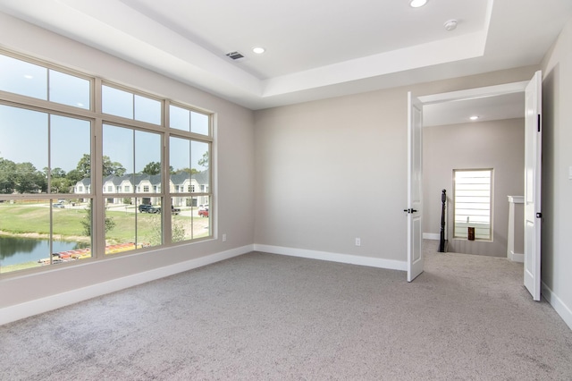 15034 Wunderlust Ln, Houston, TX 77069 - empty room featuring light colored carpet, plenty of natural light, a water view, recessed lighting, and a raised ceiling