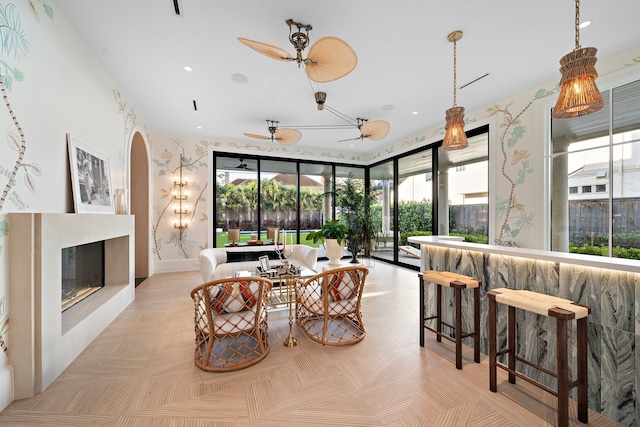 3649 Chevy Chase Dr, Houston, TX 77019 - dining room with plenty of natural light, arched walkways, a premium fireplace, a ceiling fan, and recessed lighting