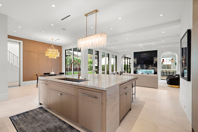 3649 Chevy Chase Dr, Houston, TX 77019 - kitchen featuring a large island, open floor plan, hanging light fixtures, light stone counters, and a chandelier