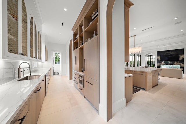 3649 Chevy Chase Dr, Houston, TX 77019 - kitchen featuring open floor plan, light stone counters, glass insert cabinets, recessed lighting, and stainless steel oven