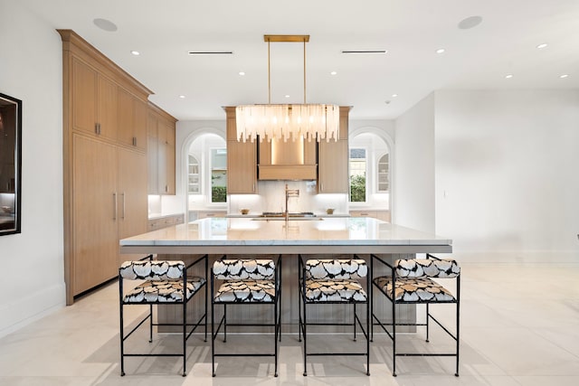 3649 Chevy Chase Dr, Houston, TX 77019 - kitchen with arched walkways, a large island, a breakfast bar, and recessed lighting