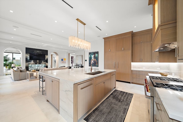 3649 Chevy Chase Dr, Houston, TX 77019 - kitchen with stainless steel range, a spacious island, open floor plan, light stone counters, and tasteful backsplash