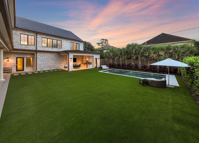 3649 Chevy Chase Dr, Houston, TX 77019 - yard at dusk featuring a fenced backyard and a patio area