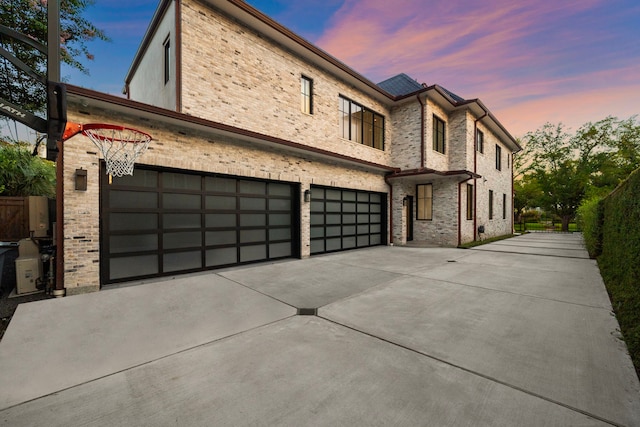 3649 Chevy Chase Dr, Houston, TX 77019 - view of front of home featuring concrete driveway, a garage, and brick siding