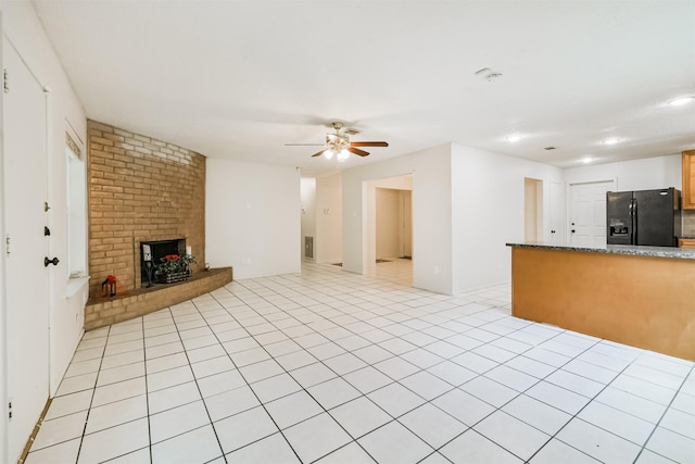 11611 Old Telegraph Rd, Houston, TX 77067 - unfurnished living room with ceiling fan, a brick fireplace, light tile patterned floors, and recessed lighting