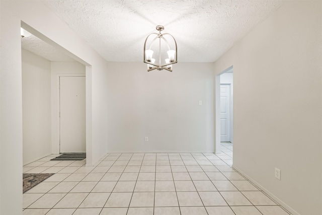 11611 Old Telegraph Rd, Houston, TX 77067 - spare room featuring a textured ceiling, a chandelier, and light tile patterned floors
