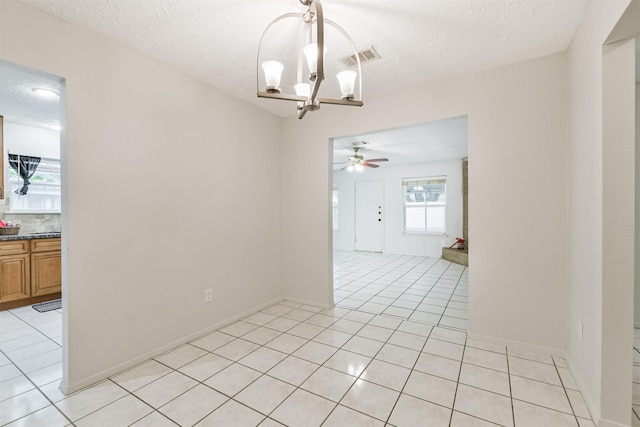 11611 Old Telegraph Rd, Houston, TX 77067 - spare room with a chandelier, light tile patterned floors, a ceiling fan, and a textured ceiling