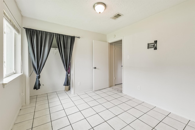 11611 Old Telegraph Rd, Houston, TX 77067 - unfurnished room with a textured ceiling, plenty of natural light, and light tile patterned floors