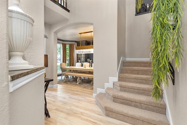 3829 Evergreen Way, Montgomery, TX 77356 - foyer entrance featuring arched walkways, wood finished floors, and stairs