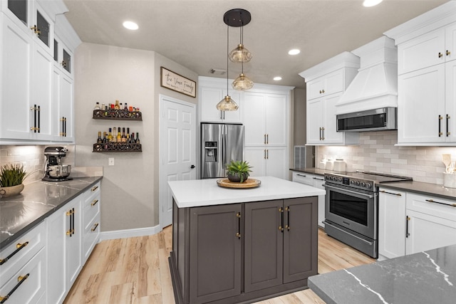 3829 Evergreen Way, Montgomery, TX 77356 - kitchen featuring appliances with stainless steel finishes, recessed lighting, white cabinets, tasteful backsplash, and a center island