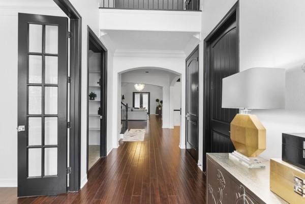 2523 Watts St, Houston, TX 77030 - hallway with arched walkways, dark wood-style floors, and crown molding