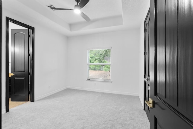 2523 Watts St, Houston, TX 77030 - unfurnished bedroom with carpet floors, a tray ceiling, and a ceiling fan