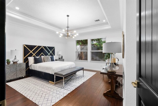 2523 Watts St, Houston, TX 77030 - bedroom featuring a tray ceiling, ornamental molding, a chandelier, wood-type flooring, and recessed lighting