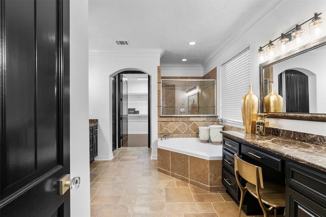 2523 Watts St, Houston, TX 77030 - bathroom with ornamental molding, vanity, a garden tub, a shower stall, and a closet