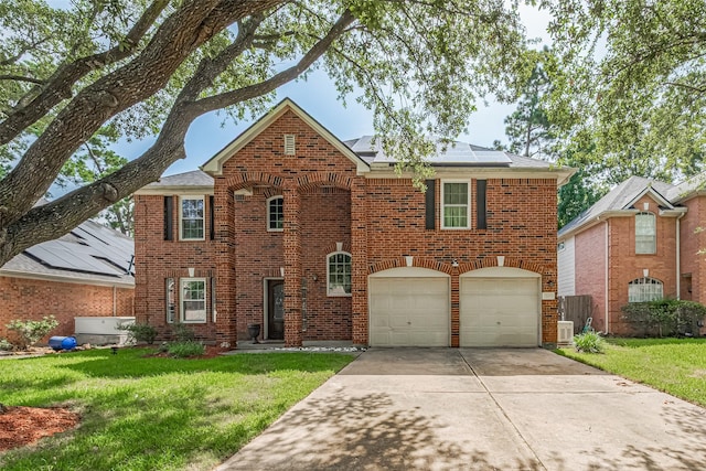 16410 Great Frst, Humble, TX 77346 - view of front of property with brick siding, a front lawn, roof mounted solar panels, and driveway