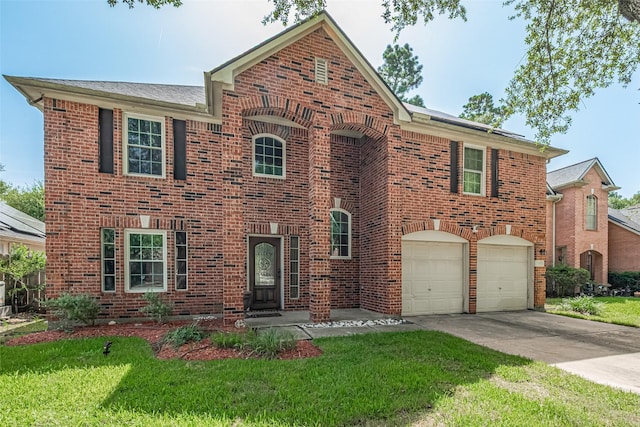 16410 Great Frst, Humble, TX 77346 - view of front of home with brick siding, a front yard, concrete driveway, and a garage