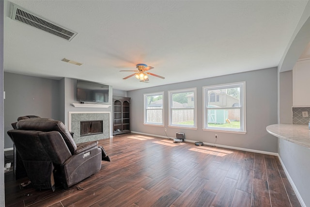 16410 Great Frst, Humble, TX 77346 - living room featuring dark wood finished floors, a tile fireplace, and ceiling fan