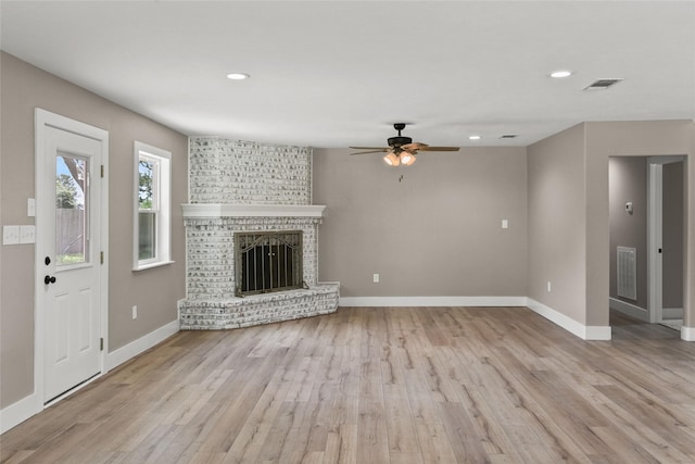 318 Primrose Rd, Jones Creek, TX 77541 - unfurnished living room with a ceiling fan, wood finished floors, recessed lighting, and a brick fireplace