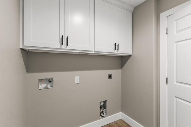 318 Primrose Rd, Jones Creek, TX 77541 - laundry area with hookup for an electric dryer, cabinet space, hookup for a washing machine, and light wood-style flooring