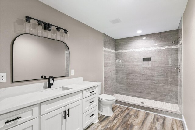 318 Primrose Rd, Jones Creek, TX 77541 - bathroom with vanity, wood finished floors, a tile shower, and recessed lighting
