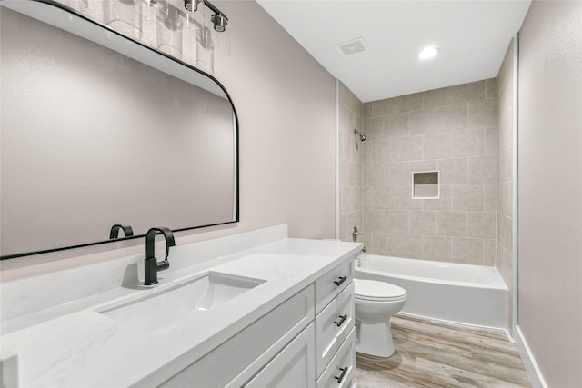 318 Primrose Rd, Jones Creek, TX 77541 - full bathroom with wood finished floors, vanity, shower / bathtub combination, and recessed lighting