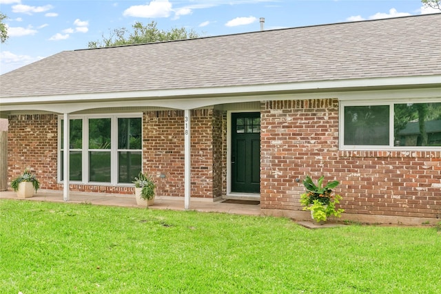 318 Primrose Rd, Jones Creek, TX 77541 - doorway to property featuring roof with shingles and a lawn