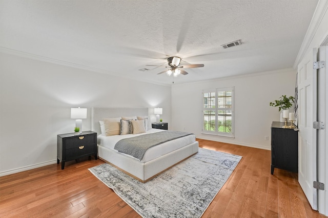 6711 Walton Heath Dr, Houston, TX 77069 - bedroom with light wood finished floors, crown molding, a textured ceiling, and a ceiling fan