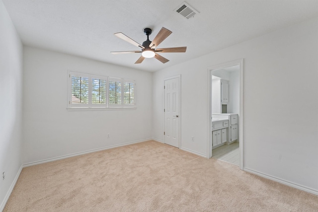 6711 Walton Heath Dr, Houston, TX 77069 - unfurnished bedroom featuring light carpet, ensuite bathroom, and ceiling fan