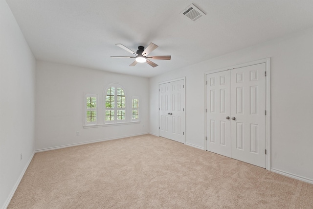 6711 Walton Heath Dr, Houston, TX 77069 - unfurnished bedroom with two closets, carpet floors, and a ceiling fan
