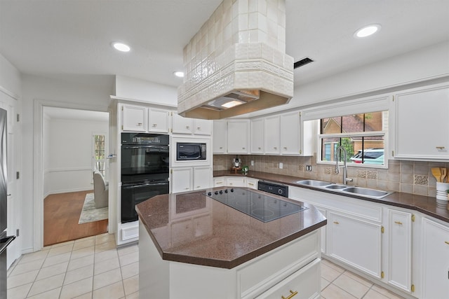 6711 Walton Heath Dr, Houston, TX 77069 - kitchen with black appliances, light tile patterned floors, white cabinets, tasteful backsplash, and recessed lighting