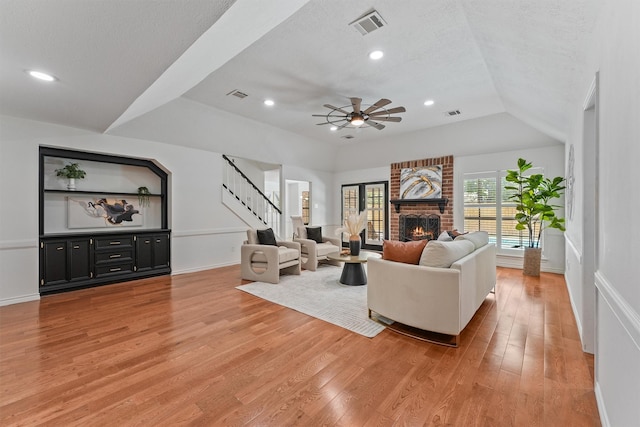 6711 Walton Heath Dr, Houston, TX 77069 - living area with light wood finished floors, stairs, a brick fireplace, ceiling fan, and recessed lighting