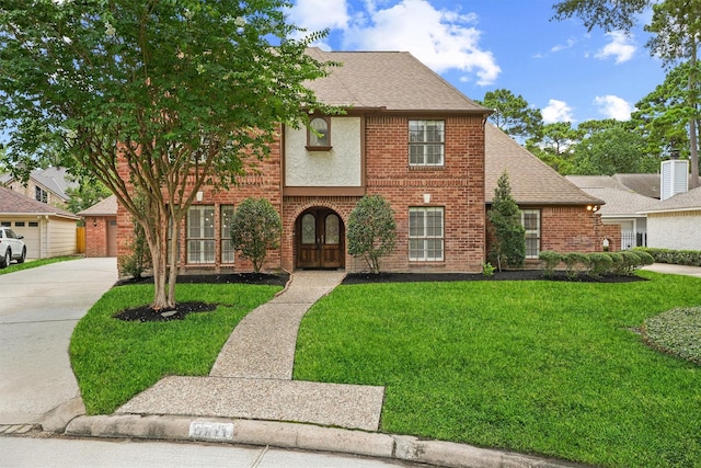 6711 Walton Heath Dr, Houston, TX 77069 - view of front of house featuring a front lawn, brick siding, and a shingled roof