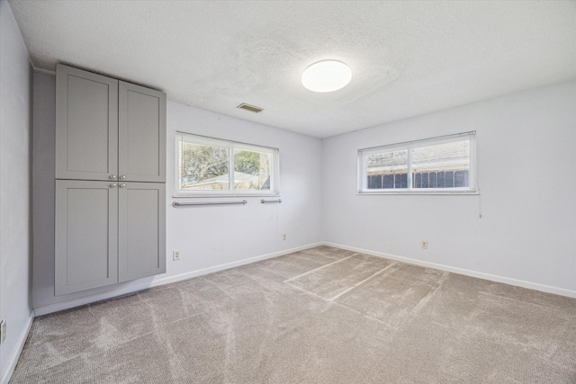 5730 Cartagena St, Houston, TX 77035 - unfurnished bedroom featuring a textured ceiling and light colored carpet