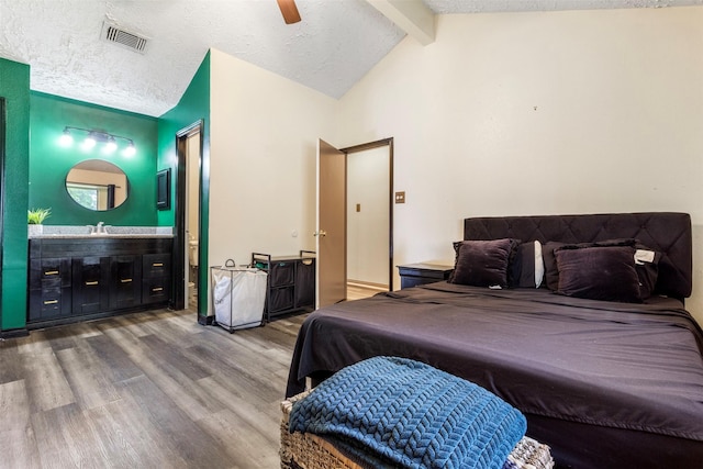 40 Crestbriar Ct, Baytown, TX 77521 - bedroom featuring wood finished floors, a textured ceiling, a ceiling fan, and connected bathroom