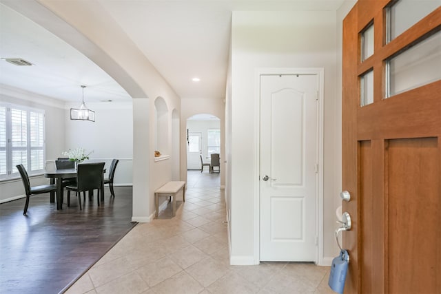 11802 Laurel Meadow Dr, Tomball, TX 77377 - foyer featuring light tile patterned flooring, arched walkways, recessed lighting, a chandelier, and ornamental molding