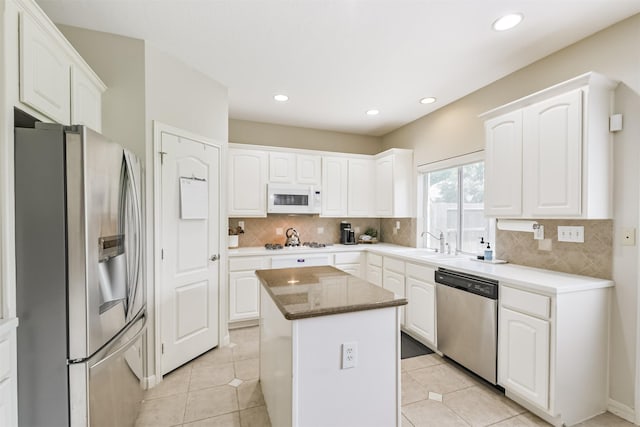 11802 Laurel Meadow Dr, Tomball, TX 77377 - kitchen featuring appliances with stainless steel finishes, a center island, white cabinets, decorative backsplash, and recessed lighting