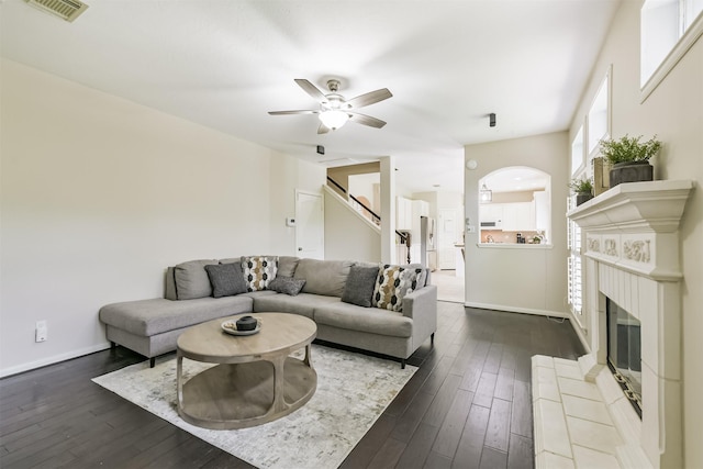 11802 Laurel Meadow Dr, Tomball, TX 77377 - living area with dark wood-type flooring, ceiling fan, a tile fireplace, and stairs