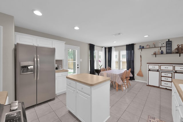 155 Fairwind Trail Dr, Conroe, TX 77385 - kitchen featuring stainless steel fridge, light countertops, light tile patterned floors, white cabinets, and recessed lighting