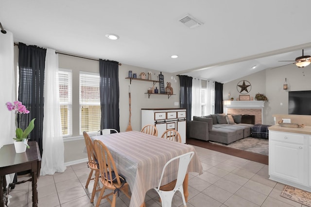 155 Fairwind Trail Dr, Conroe, TX 77385 - dining space with light tile patterned floors, vaulted ceiling, a fireplace, ceiling fan, and recessed lighting
